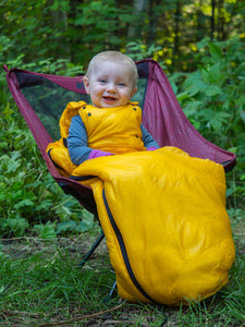 baby wearing sleeping bag in camp chair